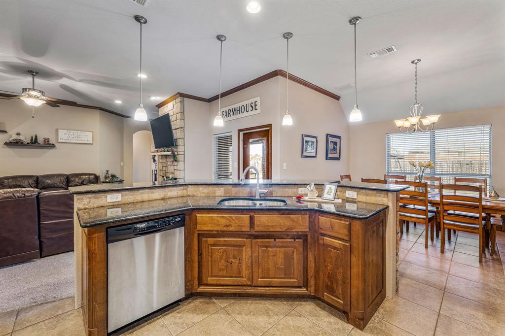 2936 Willow Ridge Circle Granbury, TX 76049 - Photo 12 of 33 a kitchen with a sink stove and table