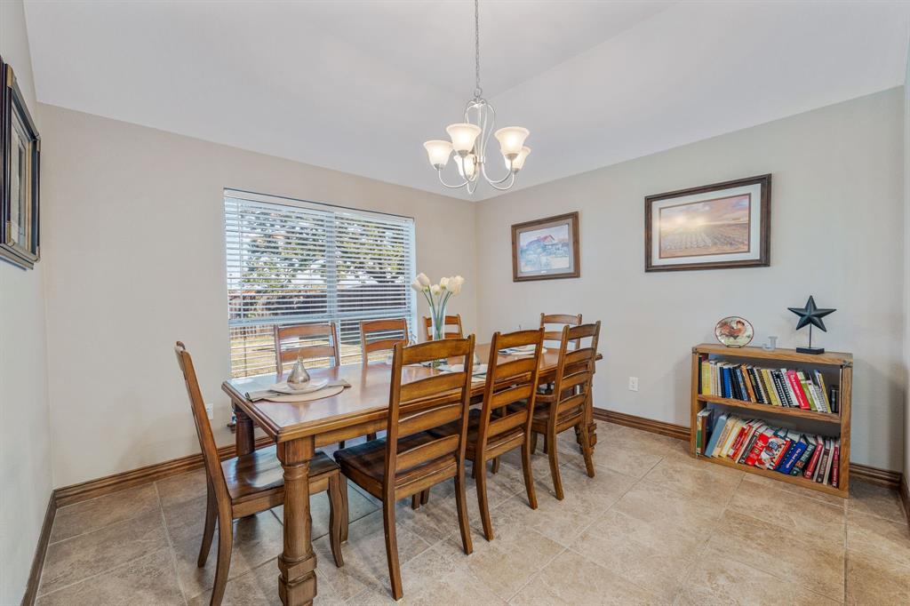 2936 Willow Ridge Circle Granbury, TX 76049 - Photo 14 of 33 a view of a dining room with furniture a rug and a book shelf