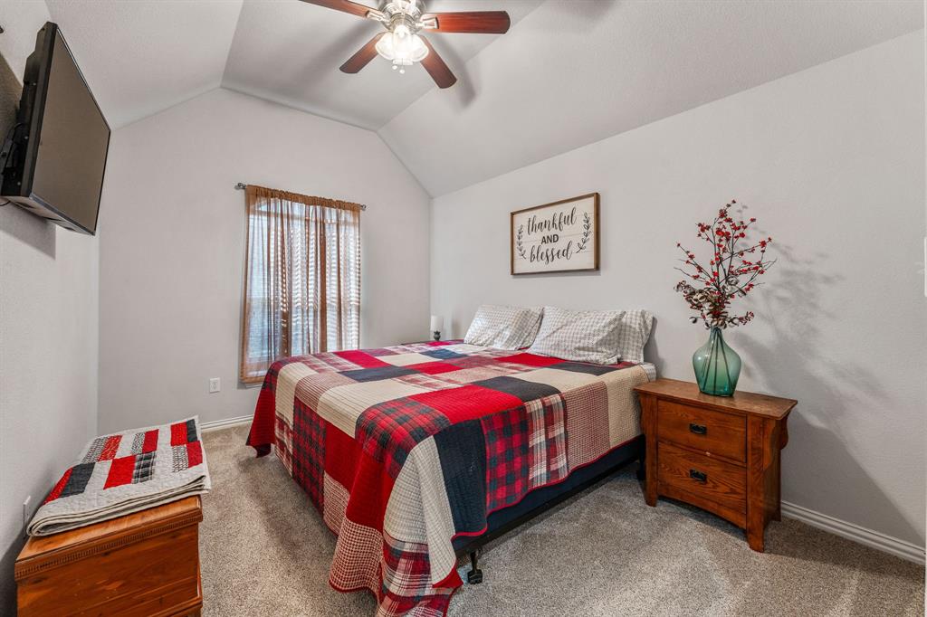 2936 Willow Ridge Circle Granbury, TX 76049 - Photo 18 of 33 a bedroom with a bed and a chandelier