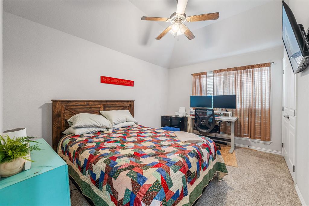 2936 Willow Ridge Circle Granbury, TX 76049 - Photo 20 of 33 a bedroom with a bed and a flat screen tv