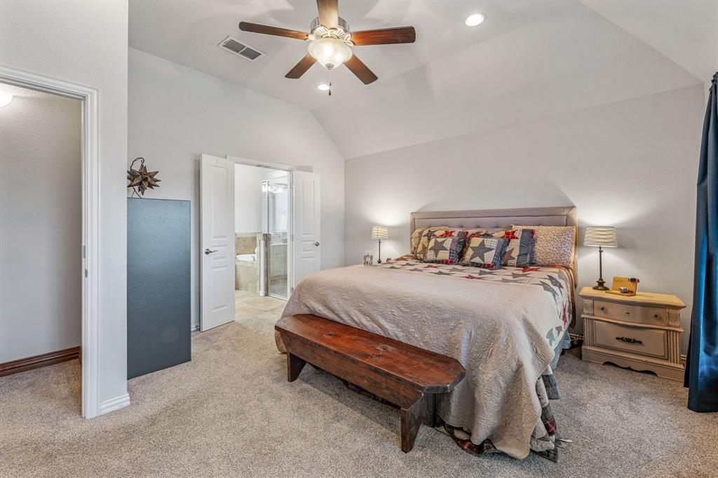 2936 Willow Ridge Circle Granbury, TX 76049 - Photo 22 of 33 a bedroom with a bed and a chandelier