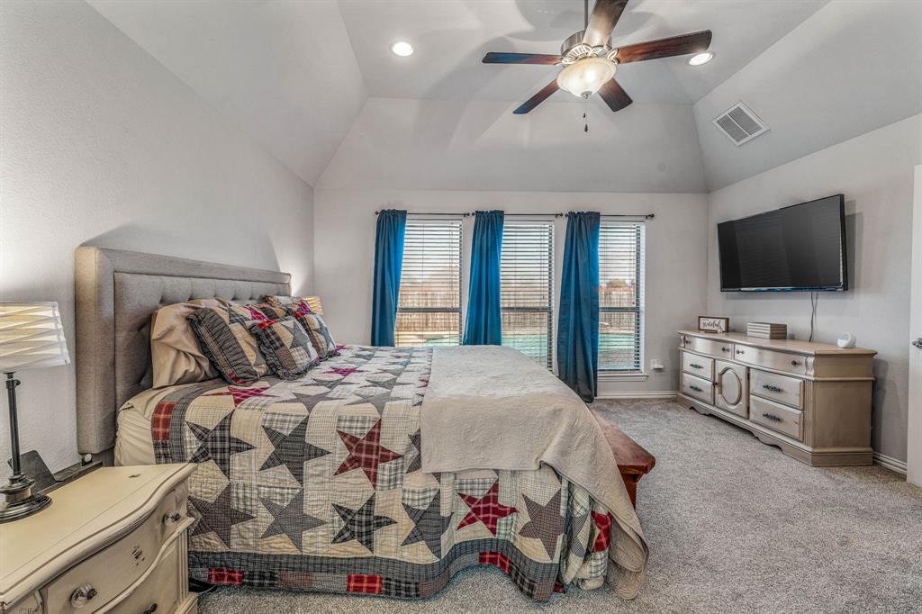 2936 Willow Ridge Circle Granbury, TX 76049 - Photo 23 of 33 a bedroom with a bed and a flat screen tv