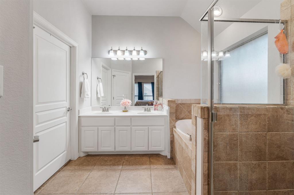2936 Willow Ridge Circle Granbury, TX 76049 - Photo 26 of 33 a bathroom with a sink a mirror and a shower