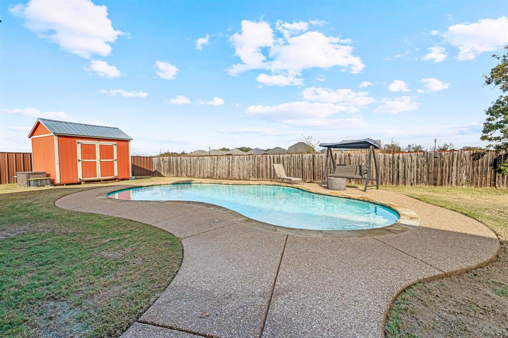 2936 Willow Ridge Circle Granbury, TX 76049 - Photo 29 of 33 a view of a swimming pool with a yard