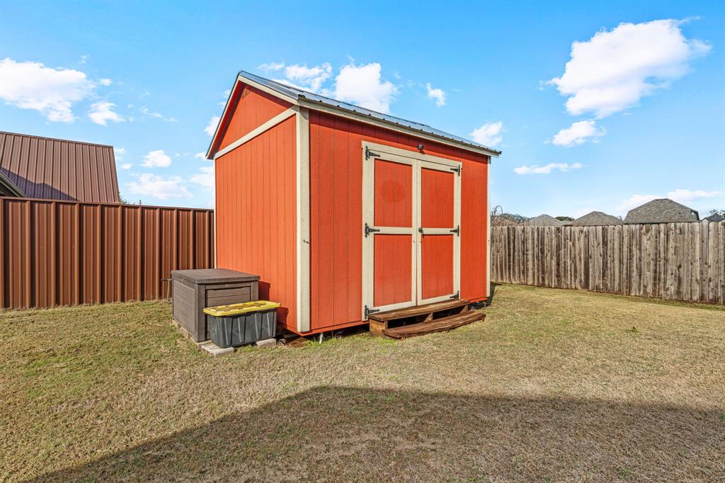 2936 Willow Ridge Circle Granbury, TX 76049 - Photo 30 of 33 a backyard of a house with table and chairs