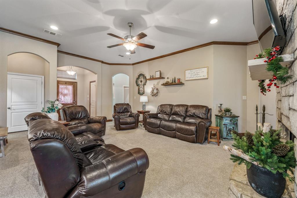2936 Willow Ridge Circle Granbury, TX 76049 - Photo 7 of 33 a living room with furniture flowers and a chandelier