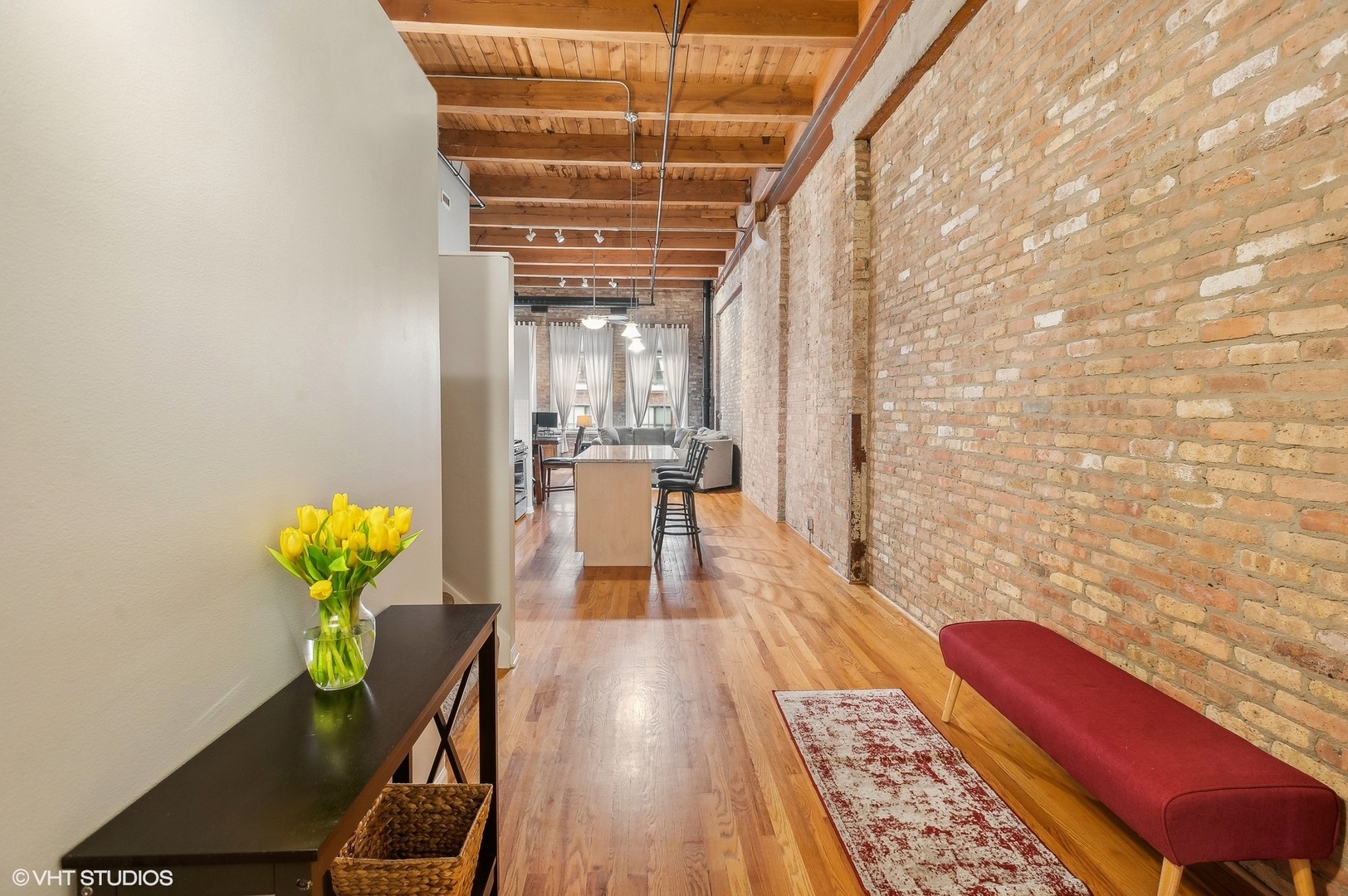 1733 West Irving Park Road, Unit 214 Chicago, IL 60613 - Photo 11 of 20 a view of a room with wooden floor and table