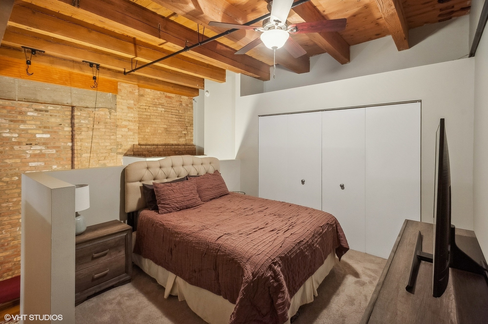 1733 West Irving Park Road, Unit 214 Chicago, IL 60613 - Photo 13 of 20 a bed sitting in a bedroom next to a window