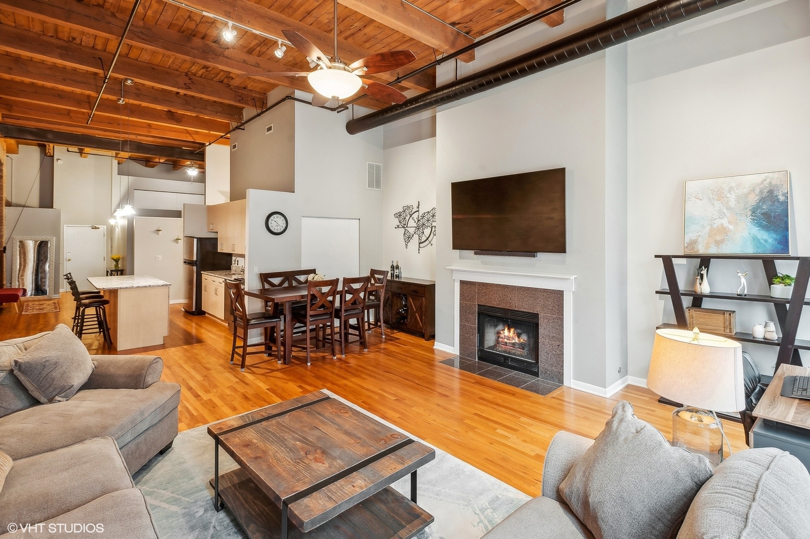 1733 West Irving Park Road, Unit 214 Chicago, IL 60613 - Photo 4 of 20 a living room with furniture and a fireplace