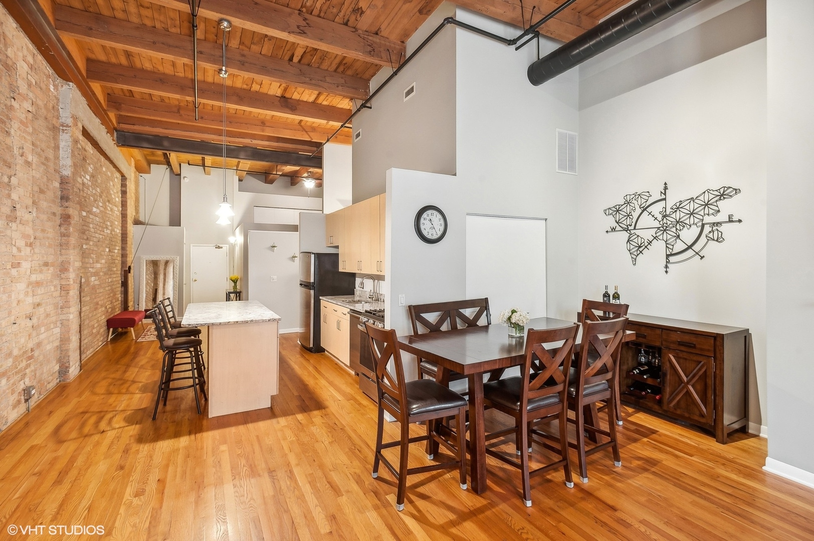 1733 West Irving Park Road, Unit 214 Chicago, IL 60613 - Photo 6 of 20 a view of a dining room with furniture and wooden floor