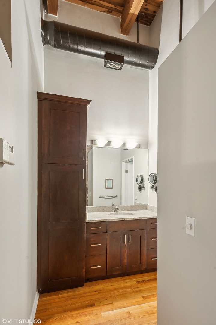 1733 West Irving Park Road, Unit 214 Chicago, IL 60613 - Photo 10 of 20 a bathroom with a double vanity sink and mirror