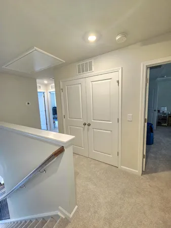 a spacious bedroom with a bed and a window