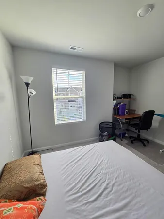 a large white kitchen with kitchen island a stove a sink and a refrigerator