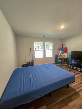 a bedroom with a bed and a chair