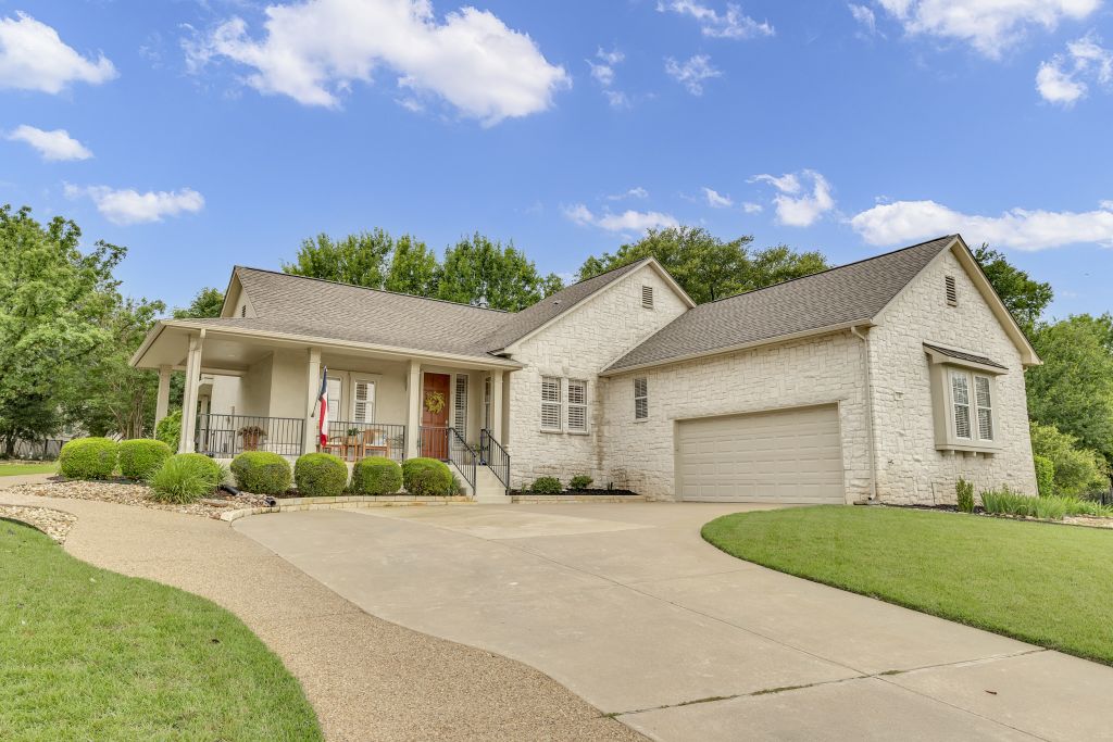 144 Cattle Trail Way Georgetown, TX 78633 - Photo 1 of 37 A graceful home with a welcoming covered front porch and an attached garage.