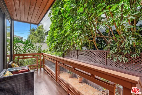 a view of balcony with wooden floor and fence