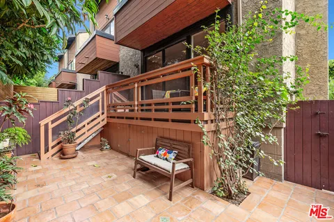 a backyard of a house with outdoor seating