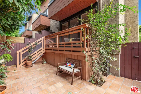 a backyard of a house with outdoor seating
