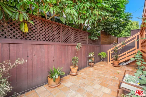 a backyard of a house with potted plants