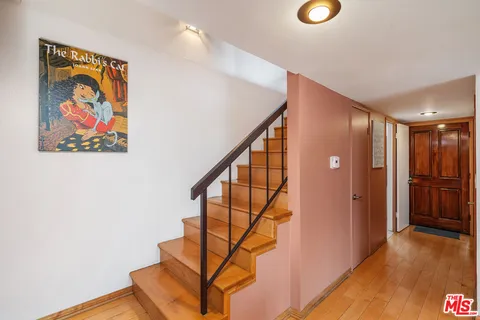 a view of entryway with stairs and wooden floor