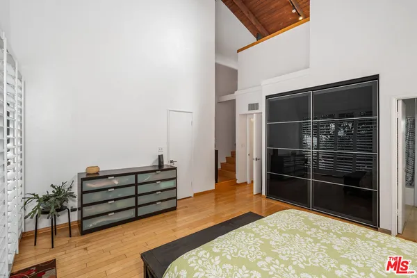 a bed room with furniture and wooden floor
