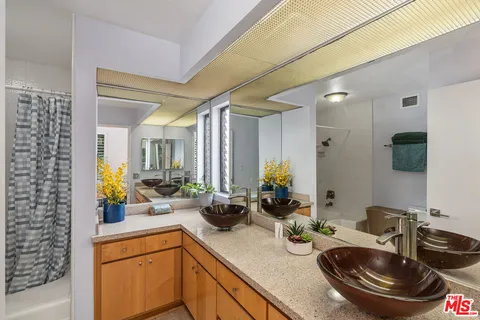 a kitchen with sink and view of living room