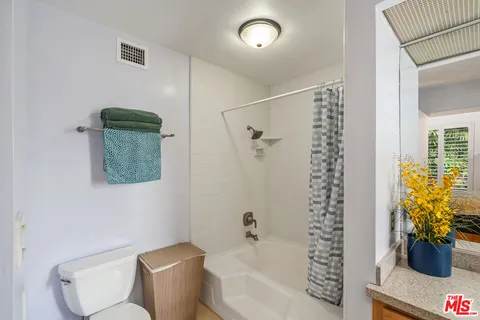 a bathroom with a shower toilet and sink