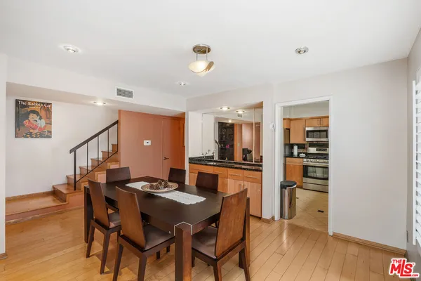 a kitchen with a table chairs and a refrigerator