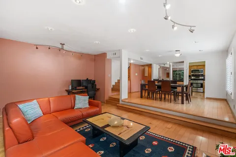 a living room with furniture pool and a table