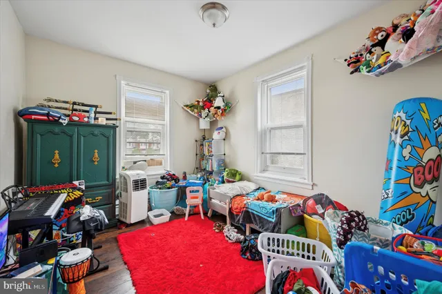 a bedroom with furniture and a wooden floor