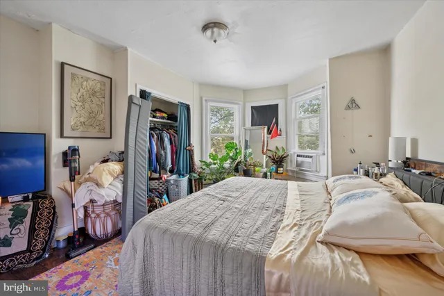 a bedroom with bed and a couch