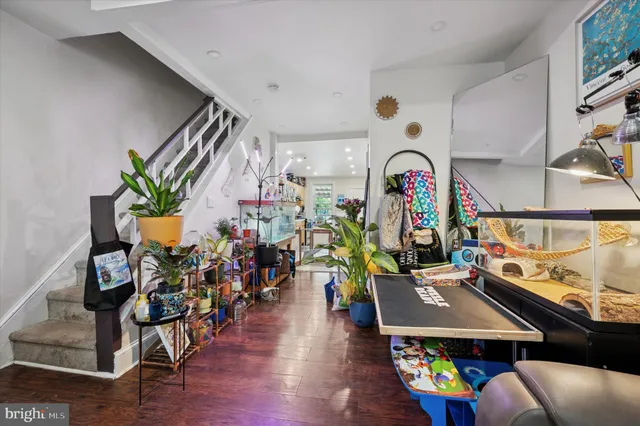 a living room with furniture and a gym equipment