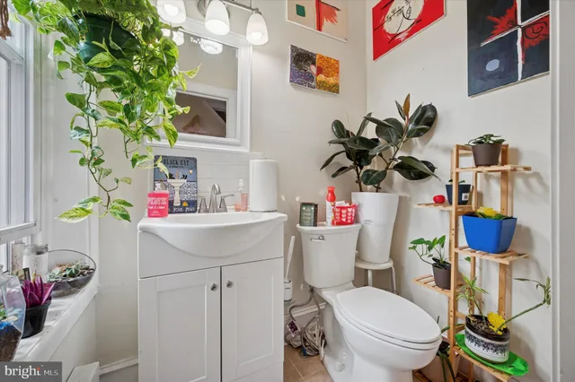 a bathroom with a sink mirror vanity and toilet