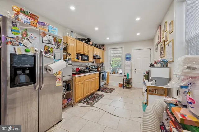 a kitchen view with lot of cabinets and refrigerator