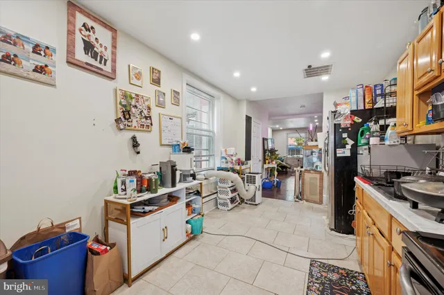 a kitchen filled with white cabinets and white appliances