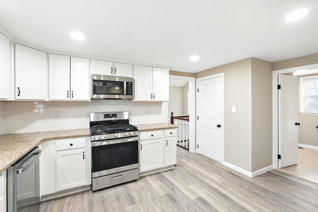 230 Sykes Street Three Rivers, MA 01080 - Photo 8 of 22 a kitchen with stainless steel appliances granite countertop a stove a sink and a microwave