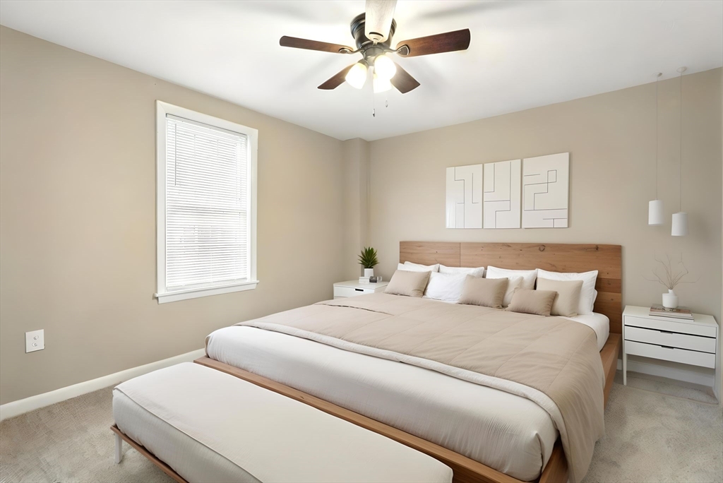 230 Sykes Street Three Rivers, MA 01080 - Photo 10 of 22 a bedroom with a large bed and a chandelier