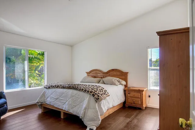 a bedroom with a bed and a large window