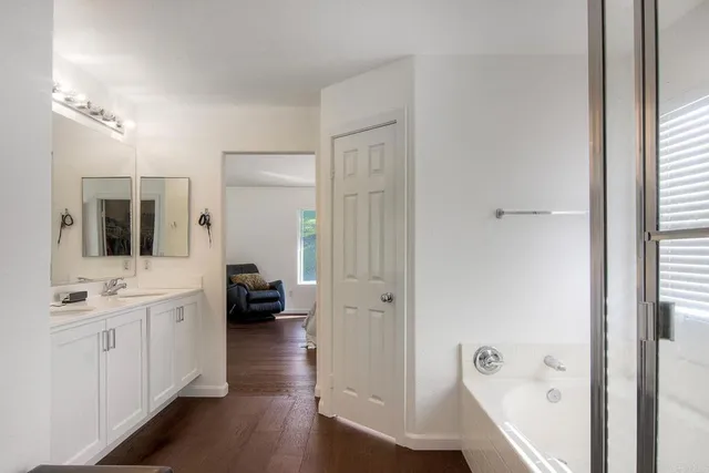 a en suite bathroom with a double vanity sink a mirror and a shower