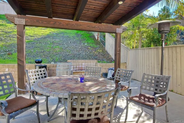 a view of an outdoor dining space with a table and chairs