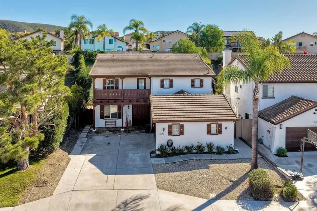 front view of a house with table and chairs