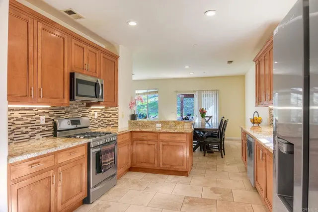 a kitchen with a sink a counter top space and stainless steel appliances