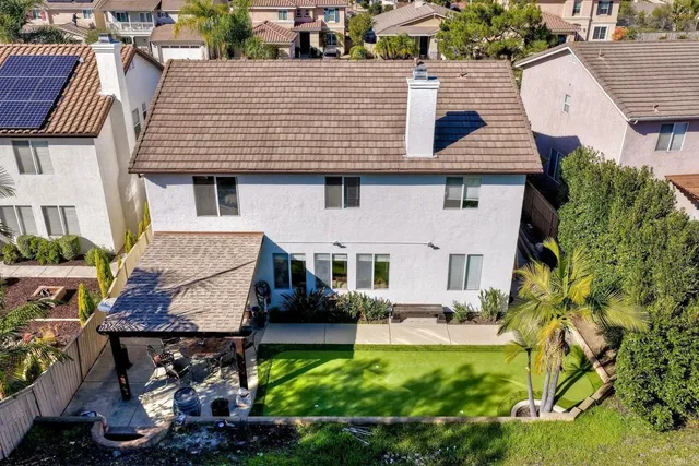 an aerial view of a house with a yard and plants
