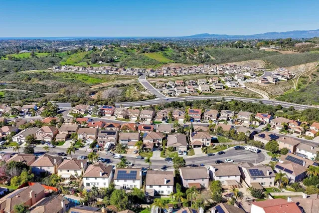 an aerial view of residential building with outdoor space and ocean view