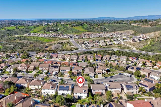 an aerial view of a house with a yard and a garden