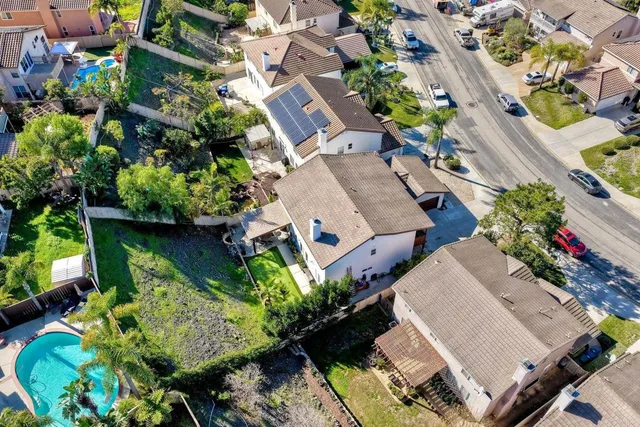 an aerial view of a house with garden and outdoor seating