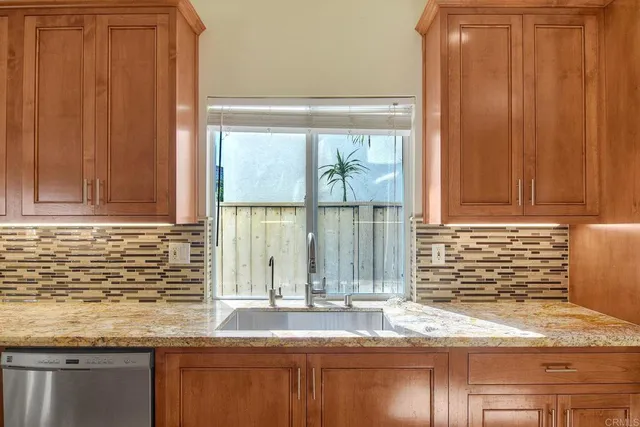 a kitchen with granite countertop a sink and a window