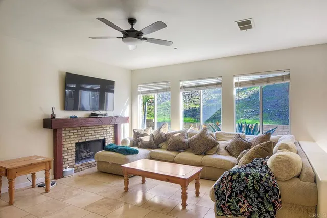 a living room with furniture a window and a fireplace