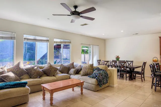 a living room with furniture a chandelier and a window