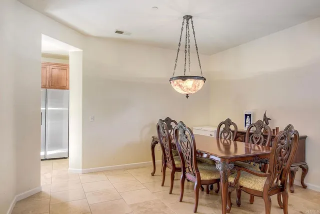 a view of a dining room with furniture and chandelier